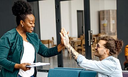 Co-workers giving each other high fives